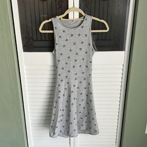 Grey dress with bird pattern. Top is fit forming while bottom flares at hips